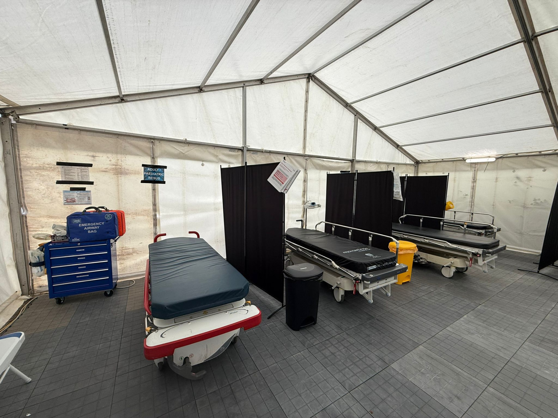 Interior of an Alba EMS treatment tent with stretchers and emergency equipment stations