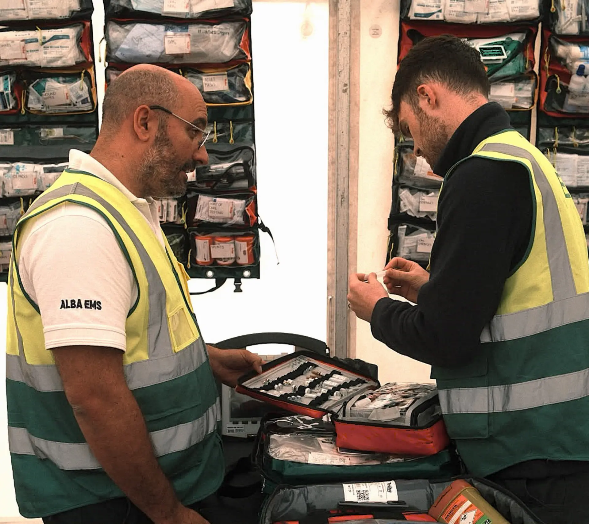 Alba EMS clinicians checking medical supplies inside an event treatment tent