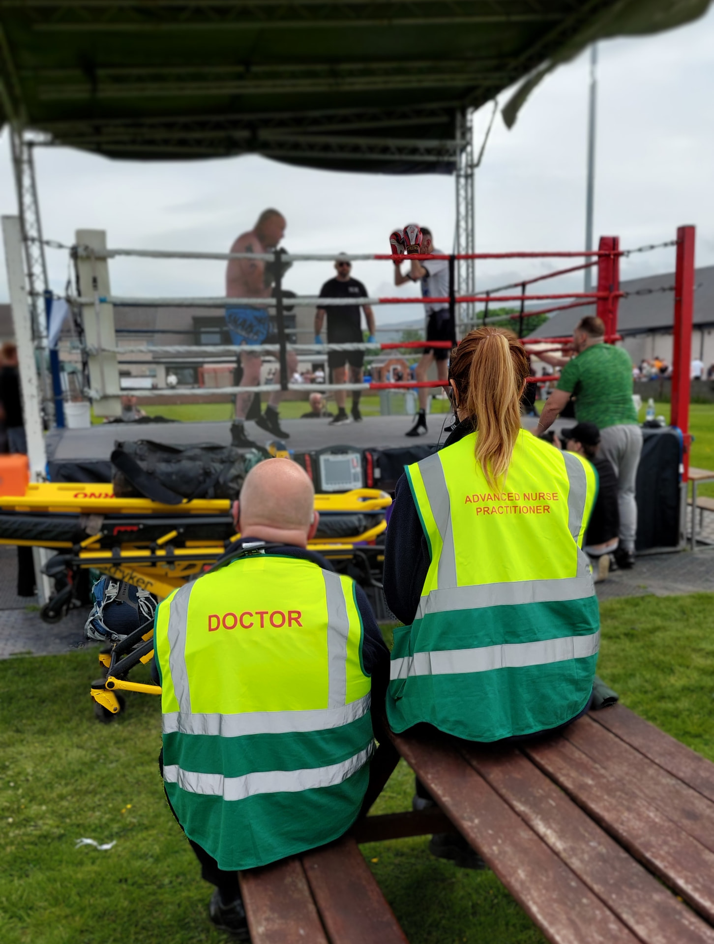 Alba EMS doctor and advanced nurse practitioner watching a boxing bout from ringside